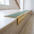 BN71SLR solid brass stair nosing in Polished Brass finish with Jade Castellated insert, fitted to a step edge