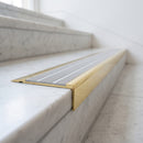 BN71SLR solid brass stair nosing in Polished Brass finish with Light Grey Castellated insert, fitted to a step edge
