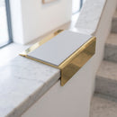 BN71SLR solid brass stair nosing in Polished Brass finish with Light Grey Smooth Textured insert, fitted to a step edge