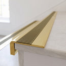 BN71SLR solid brass stair nosing in Polished Brass finish with Olive Castellated insert, fitted to a step edge
