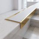 BN71SLR solid brass stair nosing in Polished Brass finish with Polar Grey Smooth Textured insert, fitted to a step edge