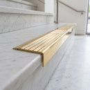 BN71SLR solid brass stair nosing in Polished Brass finish with Polished Brass insert, fitted to a step edge