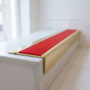 BN71SLR solid brass stair nosing in Polished Brass finish with Poppy Castellated insert, fitted to a step edge