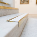 BN71SLR solid brass stair nosing in Polished Brass finish with White Castellated insert, fitted to a step edge