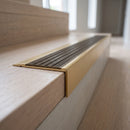 BN71SLR solid brass stair nosing in Satin Brass finish with Antique Brass insert, fitted to a step edge