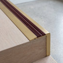 BN71SLR solid brass stair nosing in Satin Brass finish with Claret Castellated insert, fitted to a step edge