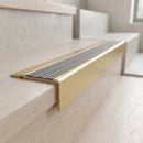 BN71SLR solid brass stair nosing in Satin Brass finish with Flint Castellated insert, fitted to a step edge