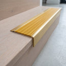 BN71SLR solid brass stair nosing in Satin Brass finish with Gold Castellated insert, fitted to a step edge
