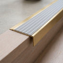 BN71SLR solid brass stair nosing in Satin Brass finish with Light Grey Castellated insert, fitted to a step edge