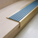 BN71SLR solid brass stair nosing in Satin Brass finish with Mid Blue Castellated insert, fitted to a step edge