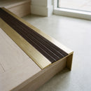 BN71SLR solid brass stair nosing in Satin Brass finish with Peat Castellated insert, fitted to a step edge