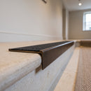 Solid brass stair nosing, 59.5mm tread with a 30mm square front, in Antique Bronze finish, fitted to a staircase