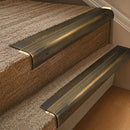 Solid brass 63.5mm bullnose stair nosing fitted to a step - Antique Brass with Antique Brass insert