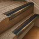 Solid brass 63.5mm bullnose stair nosing fitted to a step - Antique Brass with Black Smooth Textured insert