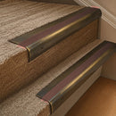 Solid brass 63.5mm bullnose stair nosing fitted to a step - Antique Brass with Claret Castellated insert