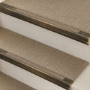 Antique Brass finish with Fawn Castellated insert - 63.5mm solid brass bullnose stair nosing fitted to a carpeted step