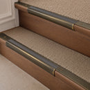 Antique Brass finish with Flint Castellated insert - 63.5mm solid brass bullnose stair nosing fitted to a carpeted step