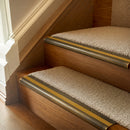 Antique Brass finish with Gold Castellated insert - 63.5mm solid brass bullnose stair nosing fitted to a carpeted step