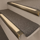 Antique Brass finish with Ivory Castellated insert - 63.5mm solid brass bullnose stair nosing fitted to a carpeted step
