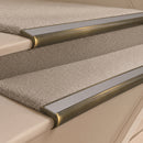 Antique Brass finish with Light Grey Smooth Textured insert - 63.5mm solid brass bullnose stair nosing fitted to a carpeted step