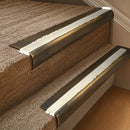 Solid brass 63.5mm bullnose stair nosing fitted to a step - Antique Brass with Porth Stone Smooth Textured insert