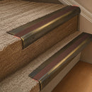 Solid brass 63.5mm bullnose stair nosing fitted to a step - Antique Brass with Rustic Castellated insert