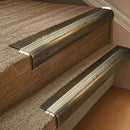 Solid brass 63.5mm bullnose stair nosing fitted to a step - Antique Brass with Satin Brass insert