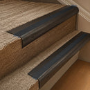 Solid brass 63.5mm bullnose stair nosing fitted to a step - Antique Bronze with Black Olympic Grip insert