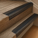 Solid brass 63.5mm bullnose stair nosing fitted to a step - Antique Bronze with Black Smooth Textured insert