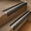 Solid brass 63.5mm bullnose stair nosing fitted to a step - Antique Bronze with Cloud Castellated insert