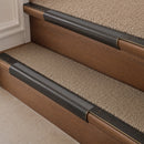 Antique Bronze finish with Flint Castellated insert - 63.5mm solid brass bullnose stair nosing fitted to a carpeted step