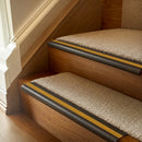 Antique Bronze finish with Gold Castellated insert - 63.5mm solid brass bullnose stair nosing fitted to a carpeted step