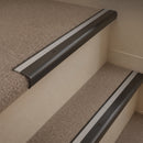 Antique Bronze finish with Light Grey Castellated insert - 63.5mm solid brass bullnose stair nosing fitted to a carpeted step