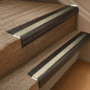 Solid brass 63.5mm bullnose stair nosing fitted to a step - Antique Bronze with Satin Brass insert