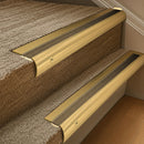 Solid brass 63.5mm bullnose stair nosing fitted to a step - Polished Brass with Antique Brass insert