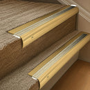 Solid brass 63.5mm bullnose stair nosing fitted to a step - Polished Brass with Satin Brass insert