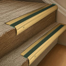 Solid brass 63.5mm bullnose stair nosing fitted to a step - Polished Brass with Spruce Castellated insert