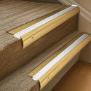 Solid brass 63.5mm bullnose stair nosing fitted to a step - Polished Brass with White Castellated insert