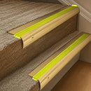 Solid brass 63.5mm bullnose stair nosing fitted to a step - Polished Brass with Yellow Castellated insert
