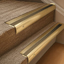 Solid brass 63.5mm bullnose stair nosing fitted to a step - Satin Brass with Antique Brass insert