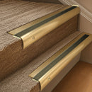 Solid brass 63.5mm bullnose stair nosing fitted to a step - Satin Brass with Antique Bronze insert