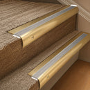 Solid brass 63.5mm bullnose stair nosing fitted to a step - Satin Brass with Cloud Castellated insert