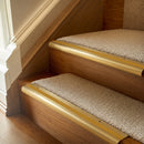 Satin Brass finish with Gold Castellated insert - 63.5mm solid brass bullnose stair nosing fitted to a carpeted step
