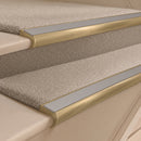 Satin Brass finish with Light Grey Smooth Textured insert - 63.5mm solid brass bullnose stair nosing fitted to a carpeted step
