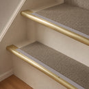 Satin Brass finish with Nimbus Castellated insert - 63.5mm solid brass bullnose stair nosing fitted to a carpeted step