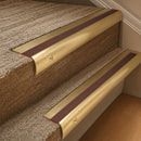 Solid brass 63.5mm bullnose stair nosing fitted to a step - Satin Brass with Rustic Castellated insert