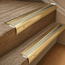 Solid brass 63.5mm bullnose stair nosing fitted to a step - Satin Brass with Satin Brass insert