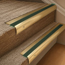 Solid brass 63.5mm bullnose stair nosing fitted to a step - Satin Brass with Spruce Castellated insert