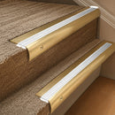 Solid brass 63.5mm bullnose stair nosing fitted to a step - Satin Brass with White Castellated insert