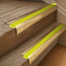 Solid brass 63.5mm bullnose stair nosing fitted to a step - Satin Brass with Yellow Castellated insert